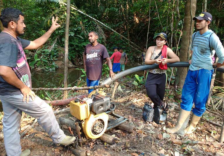 Photo by Rosamaria Loures Ageu Pereira explaining to illegal gold miners that they need to move off his community’s land