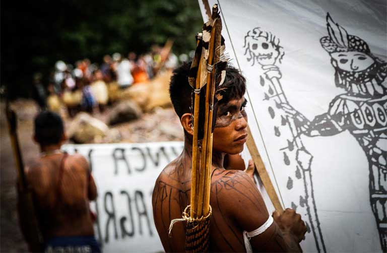 Photo by Juliana Rosa Pesqueira A Munduruku warrior prepares to occupy the São Manoel dam during a protest.